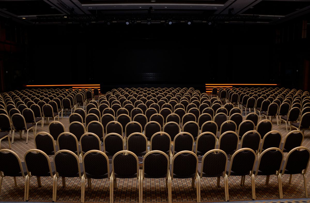 Rows of empty conference chairs before the event